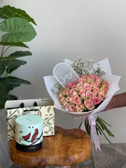 Bouquet of roses with chocolate and a planter