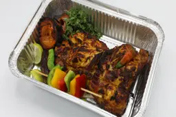 Half a piece of chicken on charcoal