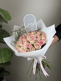 Pink rose bouquet with a plant