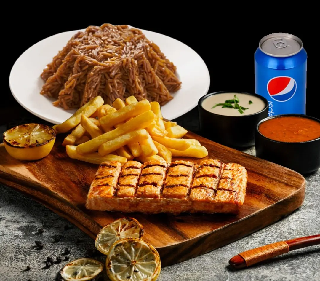 Grilled fillet salmon meal with rice and Pepsi
