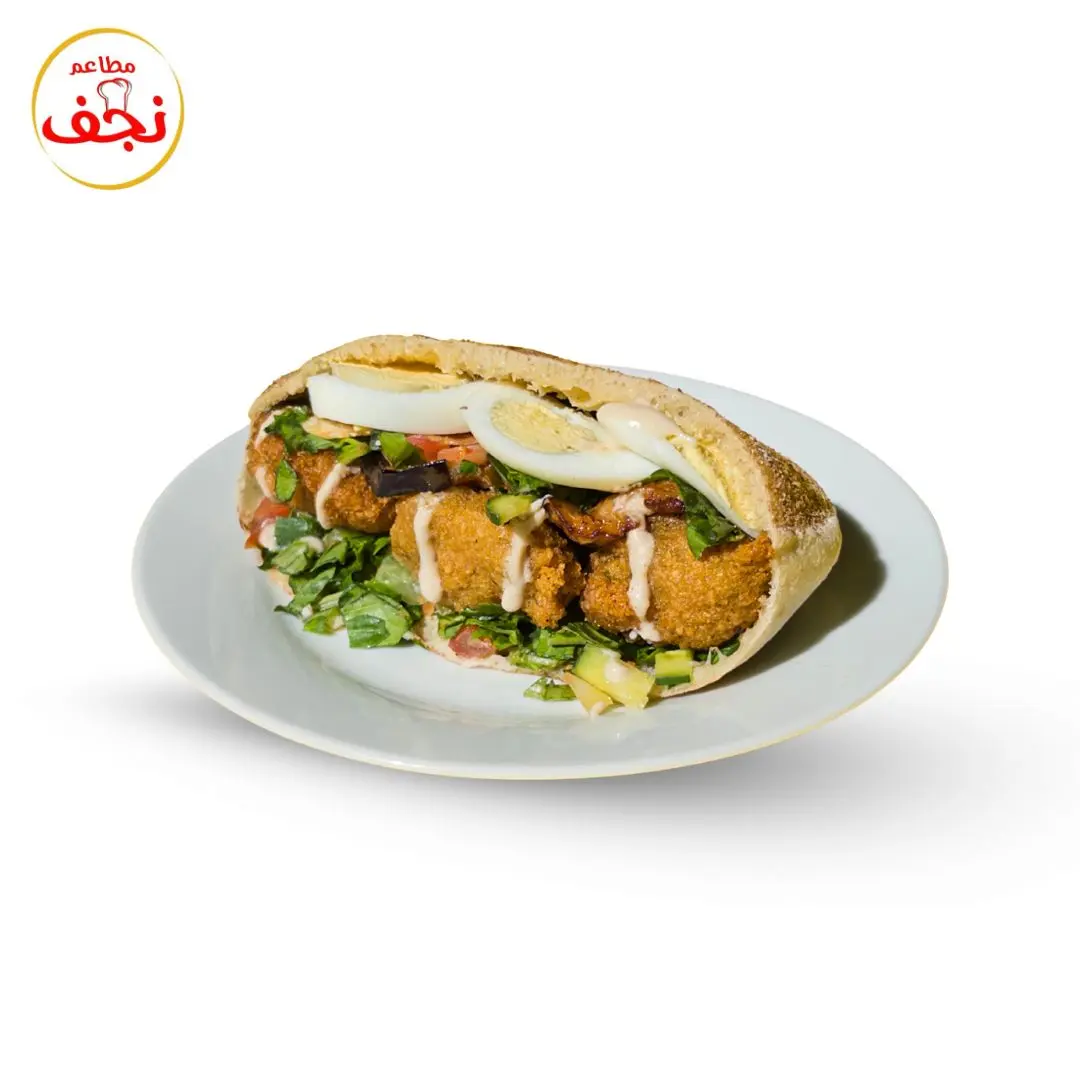 Falafel, egg, and hummus sandwich