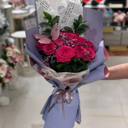 A Bouquet Of Roses And A Butterfly