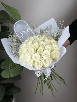 White rose bouquet with a plant
