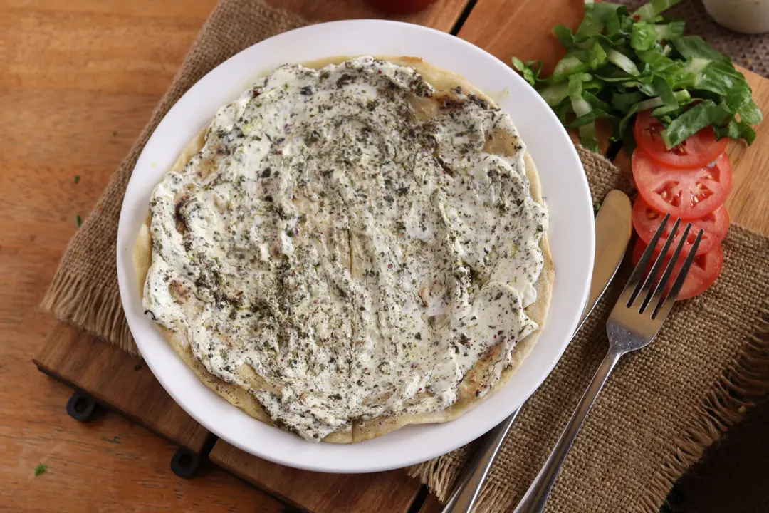 Mix Zaatar with Labneh Mana'eesh (Saj)