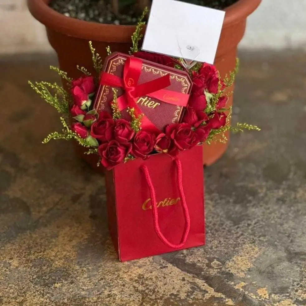 Baby rose arrangement with a Cartier necklace or bracelet
